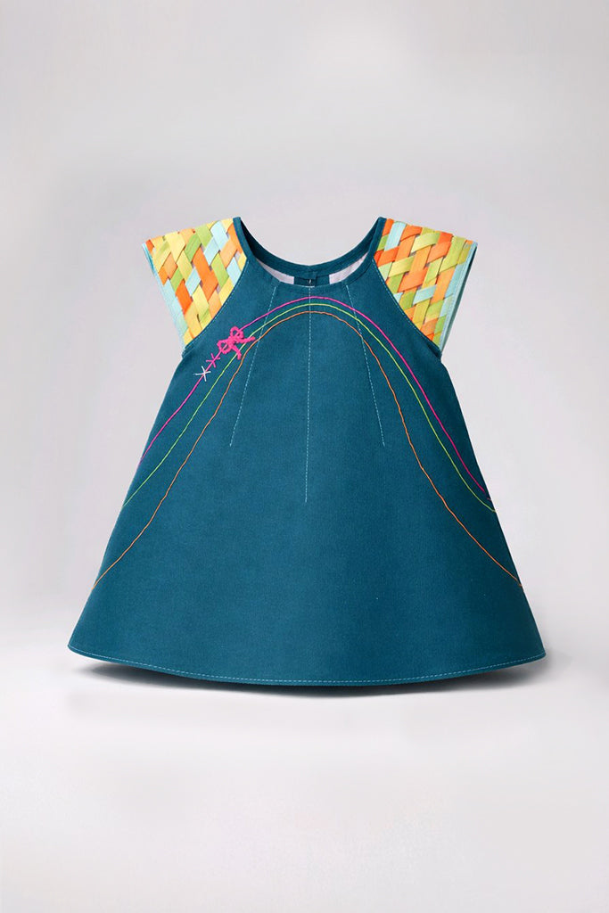 A sleeveless teal dress with a flared silhouette, featuring a colorful geometric patterned yoke on the shoulders and thin multicolored curved line details on the front.