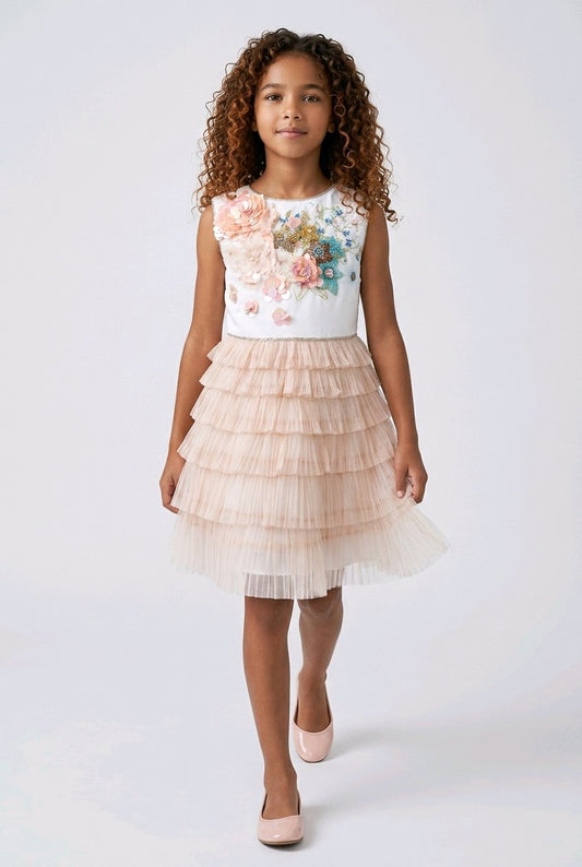 Young girl wearing a floral top and layered skirt.