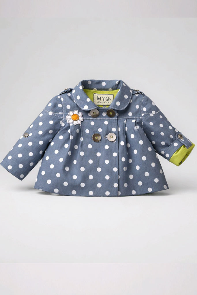 A baby girl's double-breasted coat  featuring a slate blue base with white polka dots, a daisy flower applique on the chest, and a lime green lining visible at the cuffs.