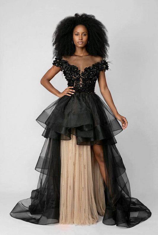 Woman wearing a black and beige evening gown with floral details.