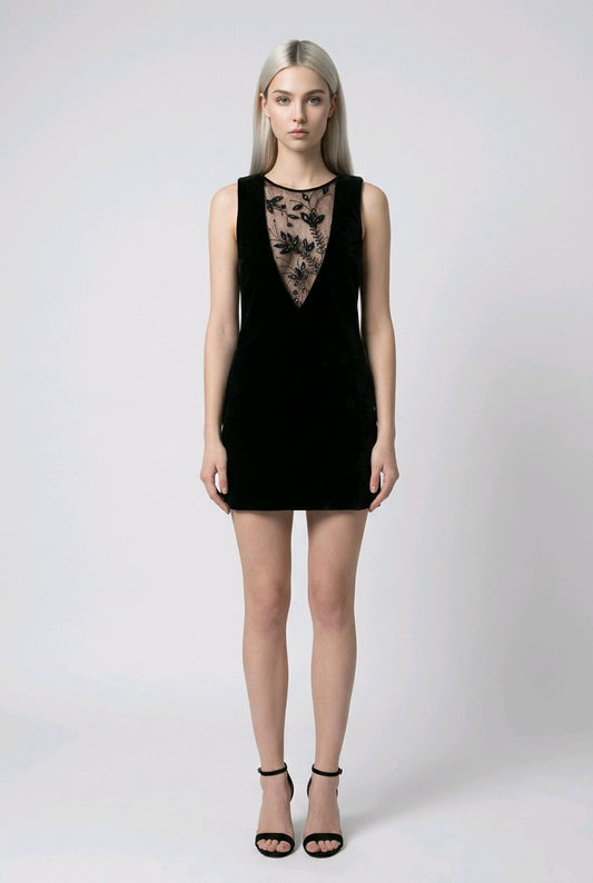 Woman wearing a black dress with lace detailing.