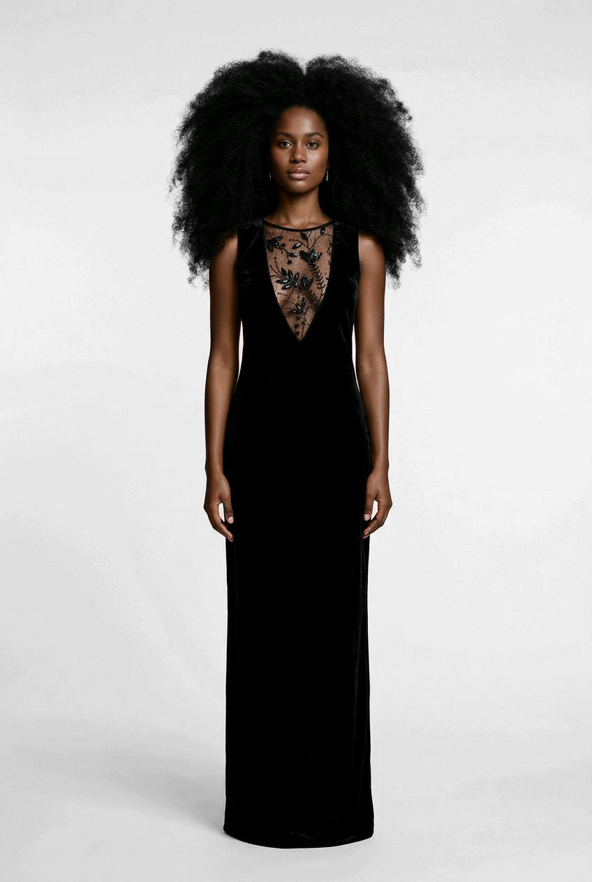 Woman wearing a black evening gown with floral lace details.