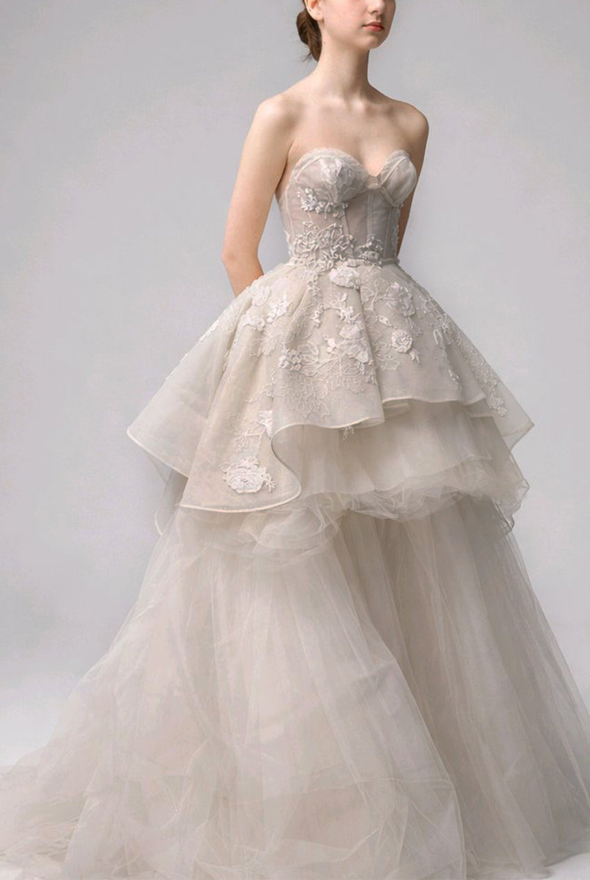 Elegant strapless wedding dress with floral details.