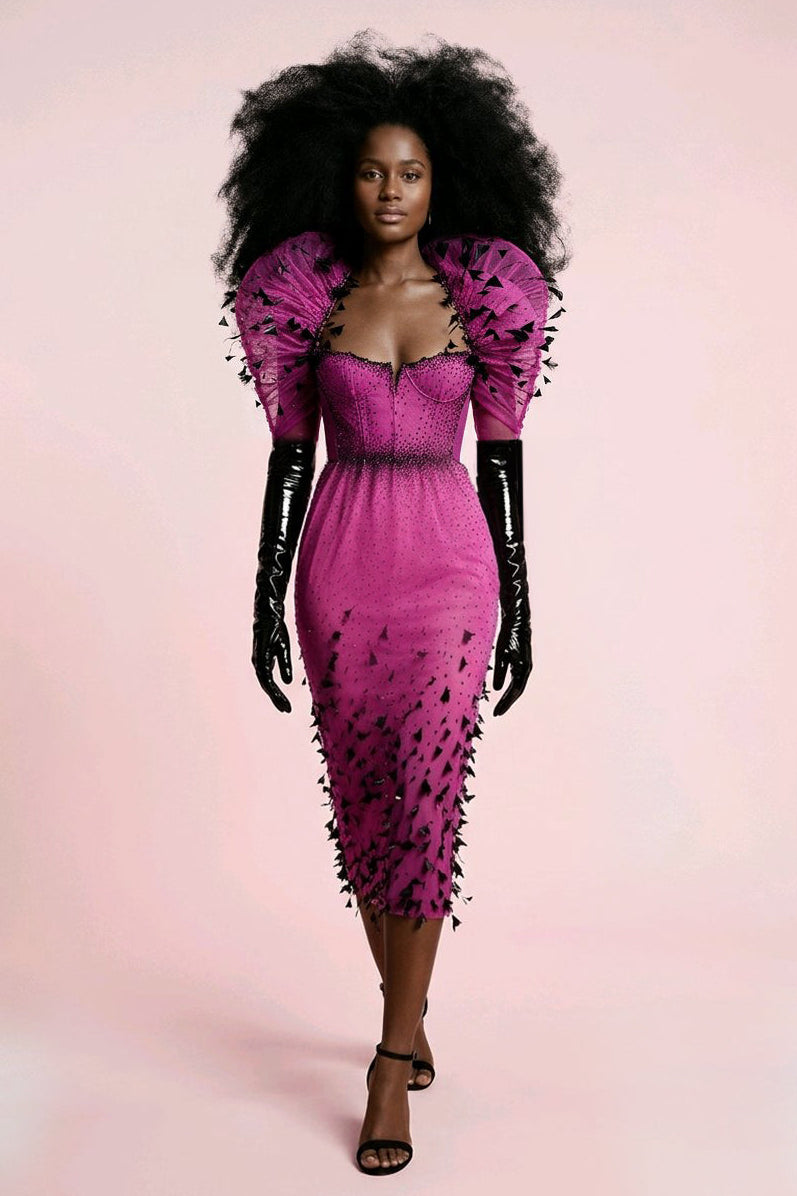 Model wearing a pink dress with black details.