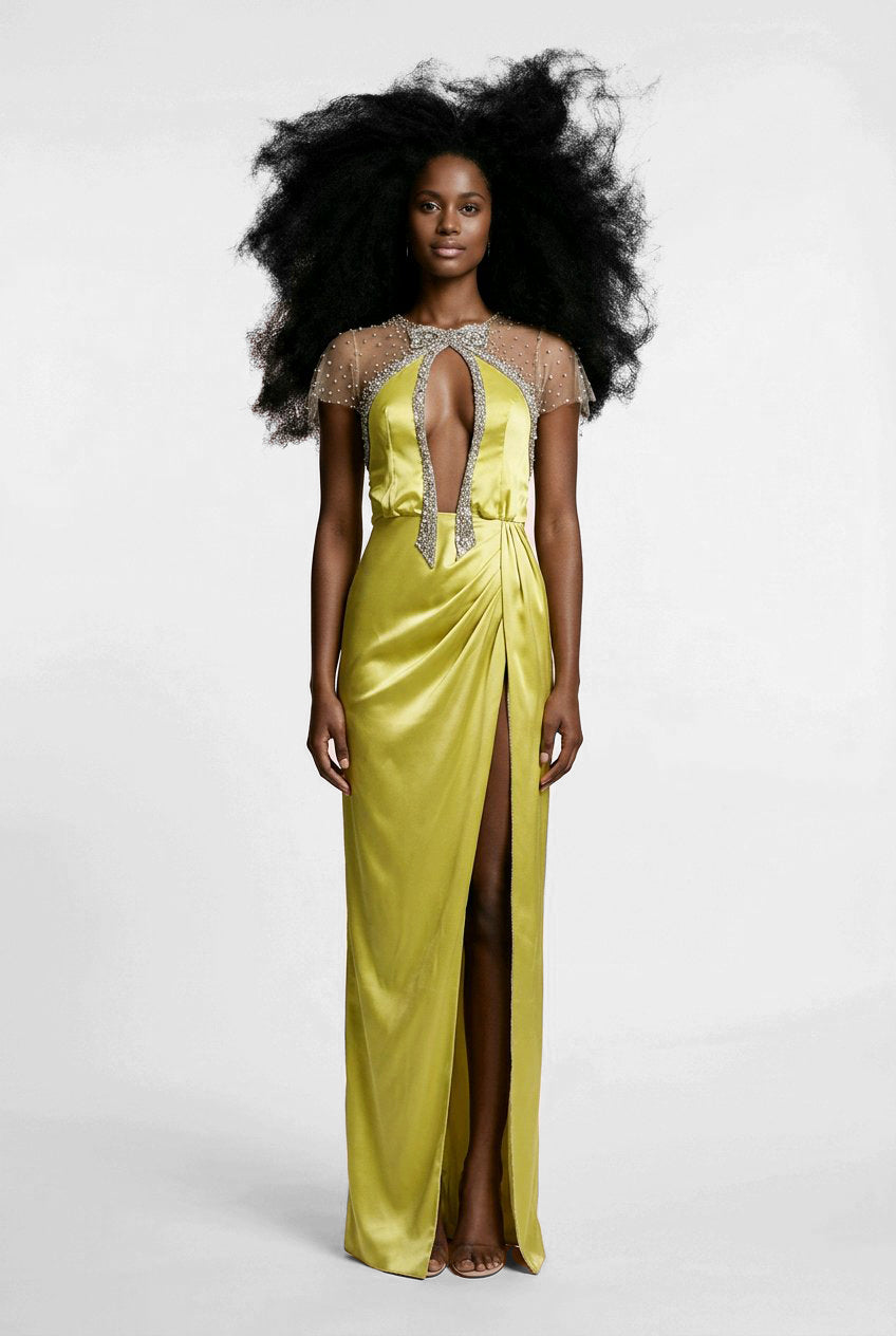 Woman wearing a yellow evening gown with intricate detailing.