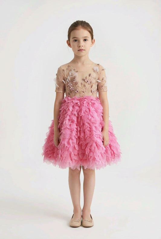 Young girl wearing a pink dress.