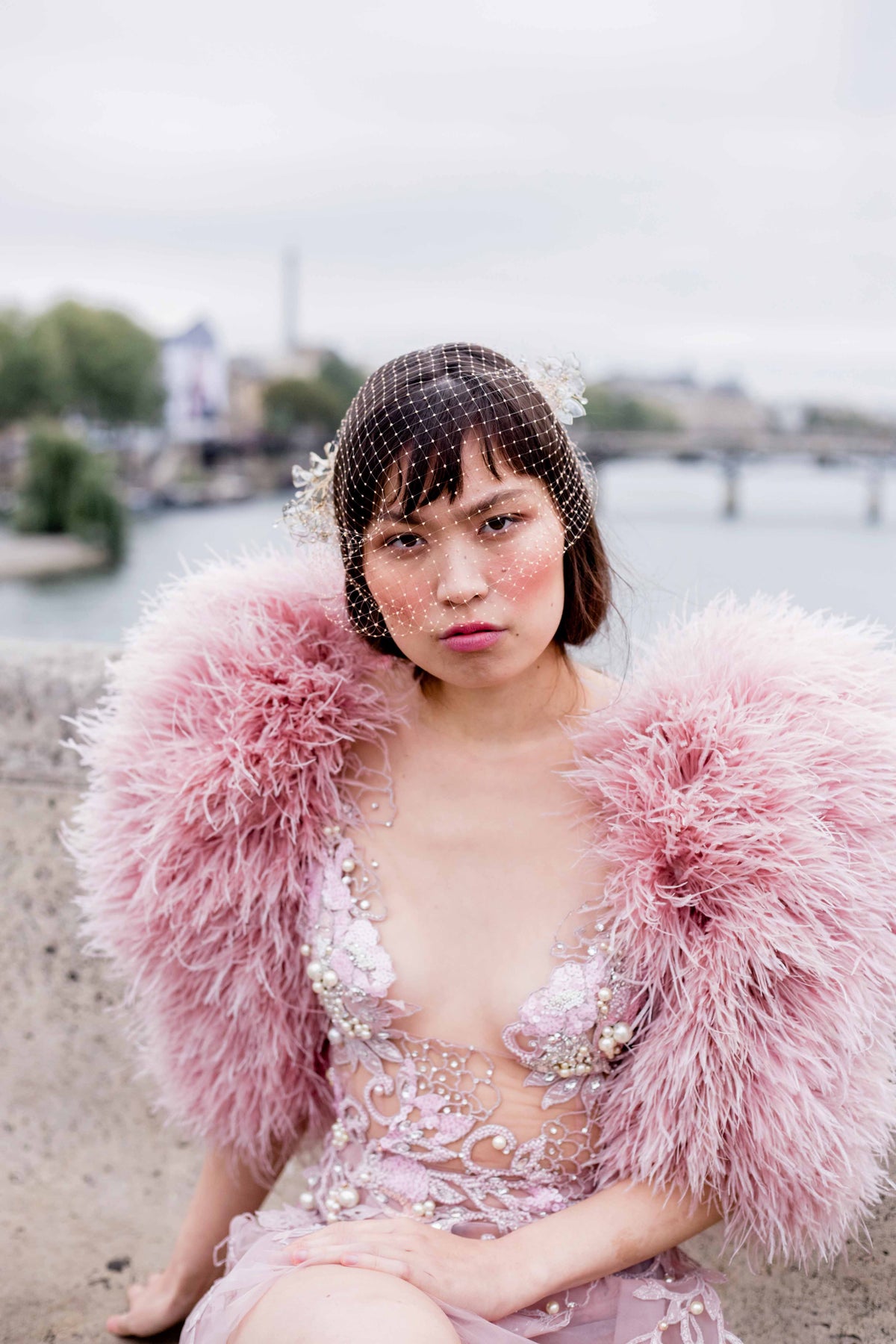 Woman wearing a pink feathered outfit.