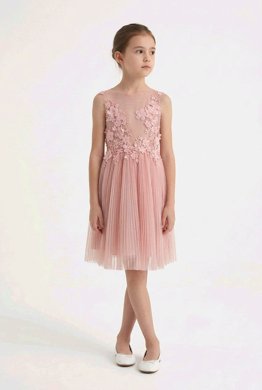 Young girl wearing a pink floral dress.