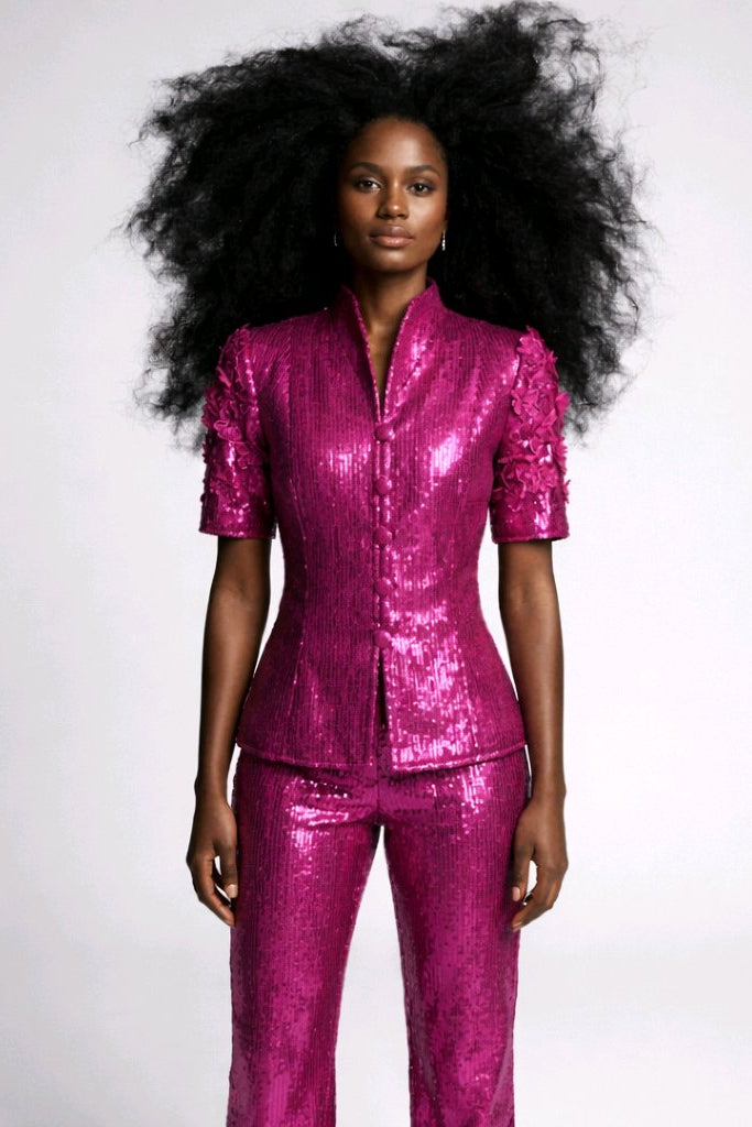 Woman wearing a shiny pink outfit.