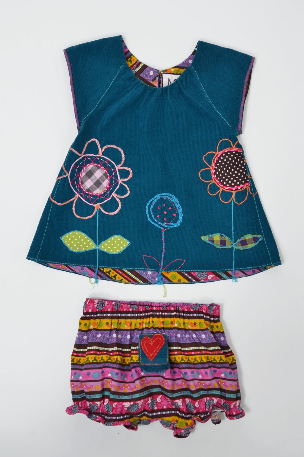 A two-piece toddler girl's outfit set consisting of a sleeve teal top with colorful floral appliques and a matching pink, purple, yellow, and black patterned ruffled bloomers.