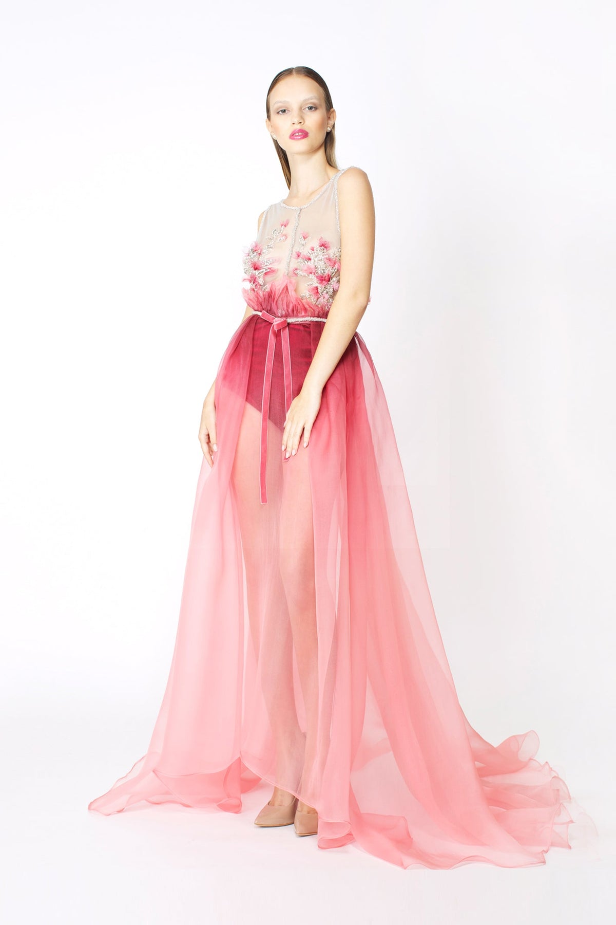 Woman wearing a pink floral dress.
