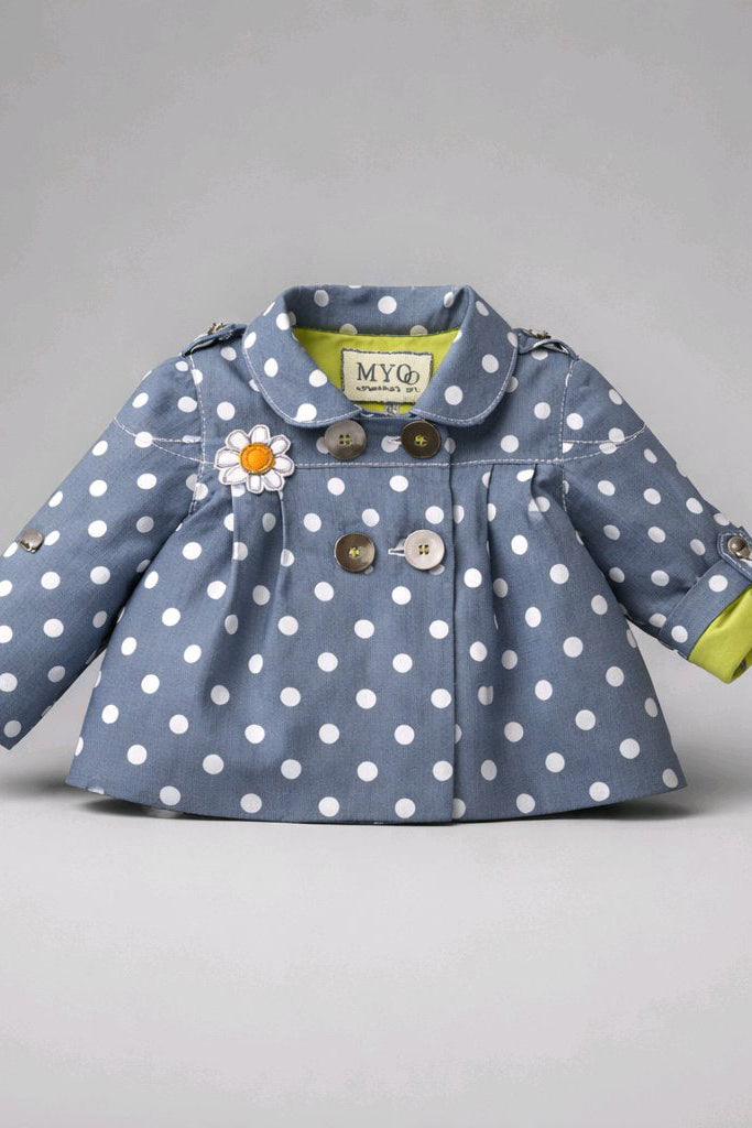 A baby girl's blue denim jacket with white polka dots, featuring a daisy applique on the chest, brown buttons, and a lime green inner lining.