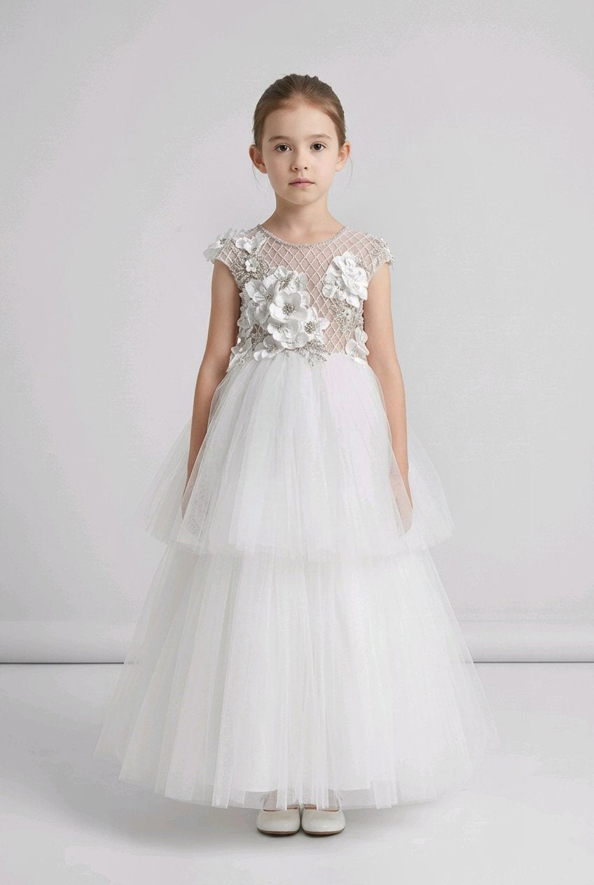 Formal white flower girl dress with a sheer mesh bodice, large white floral appliqués, cap sleeves, and a full layered tulle skirt.