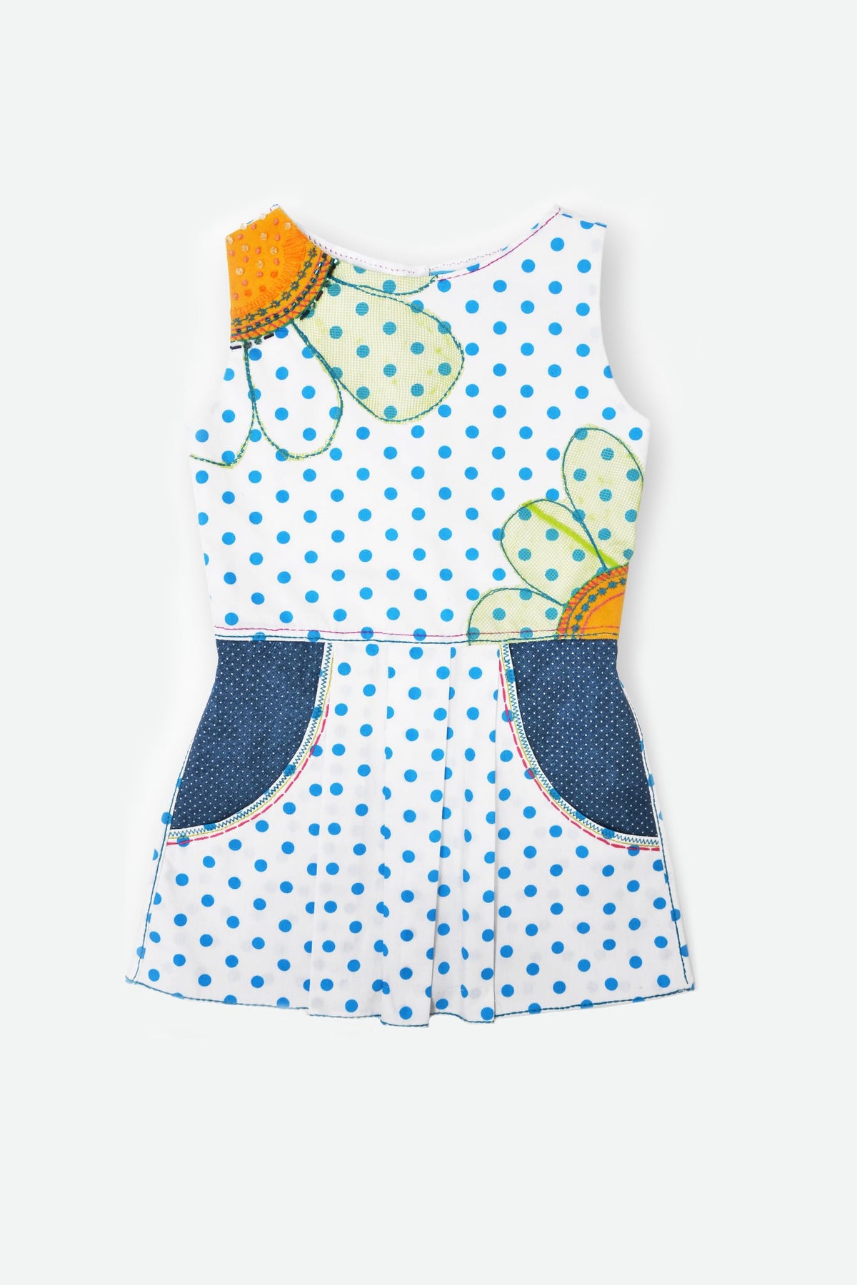 A sleeveless children's romper with a white base, demin blue polka dots, applique floral details, and dark blue denim pockets.